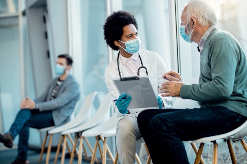 A doctor going through a medical report with an older patient
