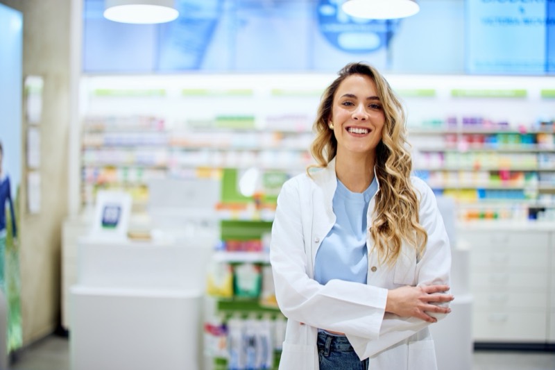 A pharmacist at work behind the counter of a community pharmacy