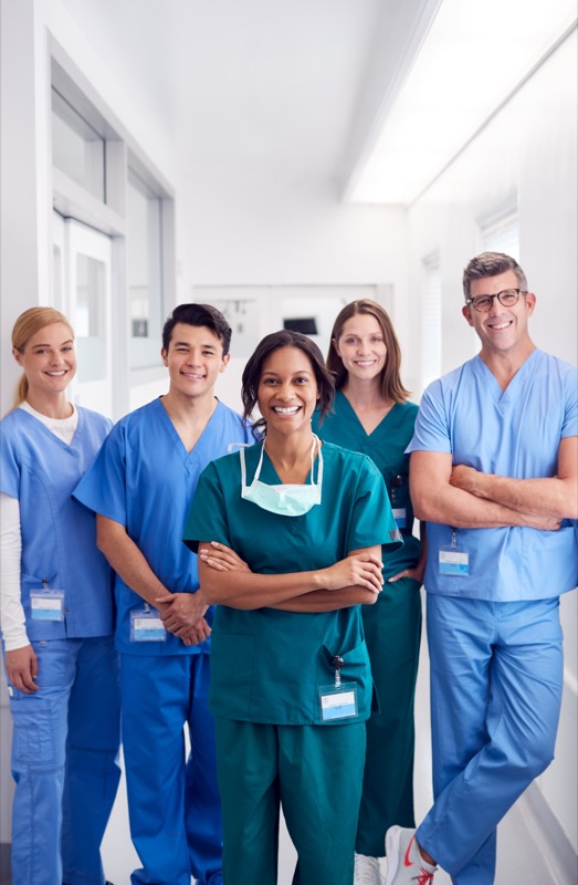 A multi-disciplinary medical team standing together in a hospital