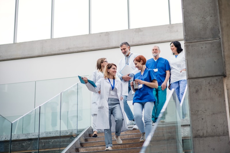 A medical team walking together down a hospital staircase